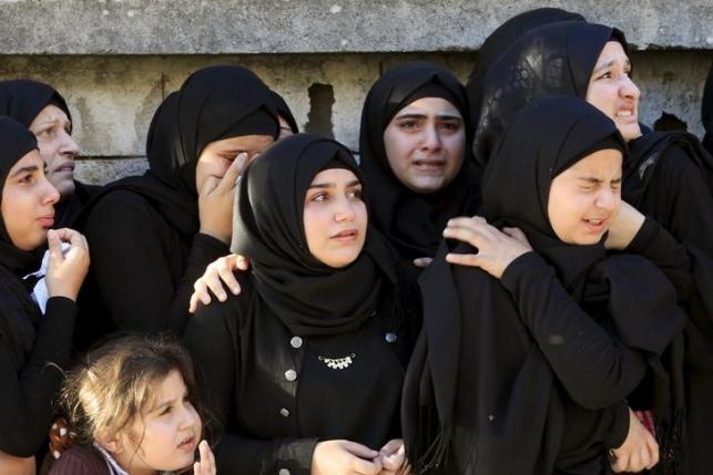 Muslim women and girls mourn during the funeral of Hezbollah member Ali Abbas Dia, who was killed in the two explosions that occurred on Thursday in Beirut's southern suburbs, during his funeral in Baflay village, southern Lebanon November 13, 2015. REUTERS/Ali Hashisho