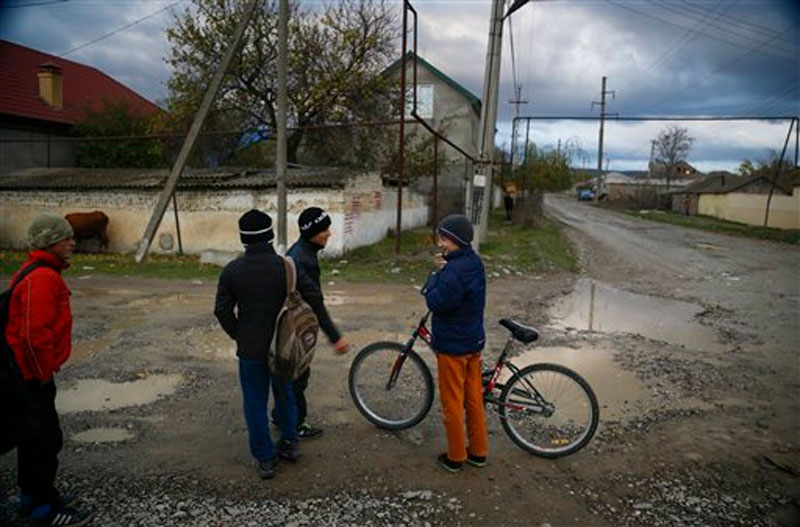 Children play in a street in the village of Komsomolskoye, Dagestan, Russia on Thursday, November 12, 2015. An epidemic of recruitment for the Islamic State group has swept through the predominantly Muslim Dagestan where young men and women are leaving for Syria, pursuing a religious ideal or trying to escape police profiling. Photo: AP