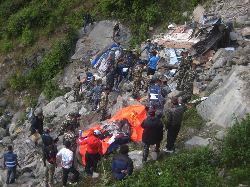 Security personnel collecting the bodies of people killed in bus accident at Ramche of Rasuwa district.