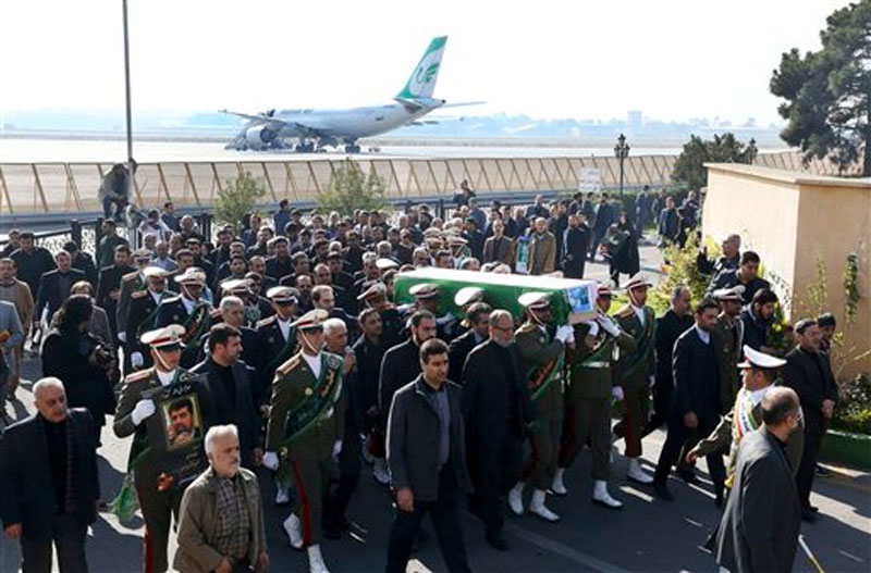 Members of the Iranian army honor guard carry the flag draped coffin of Ghazanfar Roknabadi, former Iranian ambassador to Lebanon who had been missing since the Saudi hajj stampede in September, from Saudi Arabia at the Mehrabad airport in Tehran, Iran, Friday, November 27, 2015. Photo: AP 
