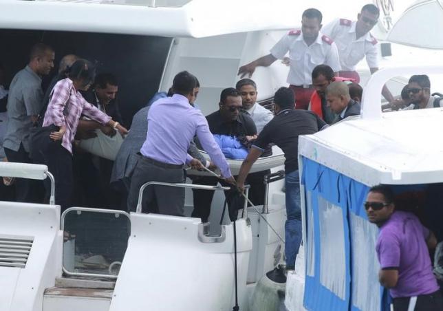 Officials carry an injured woman off the speed boat of Maldives President Abdulla Yameen (not pictured) after an explosion onboard, in Male, Maldives September 28, 2015. REUTERS/Waheed Mohamed/Files