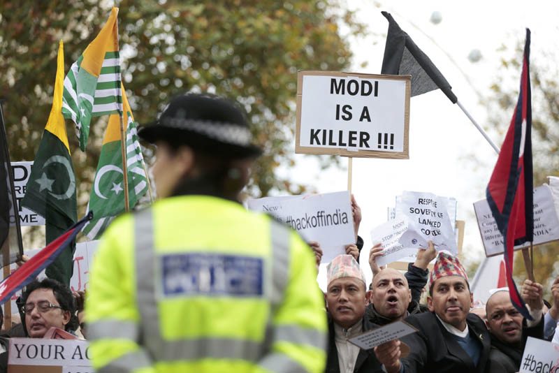 A police officer keeps an eye on demontrators protesting opposite Downing Street against India's Prime Minister Narendra Modi's official visit, in London, November 12, 2015. Photo: Reuters