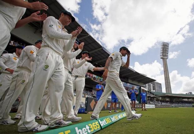 Australia's Mitchell Johnson (R) leads his team mates onto the ground at the start of New Zealand's second innings during the fifth day of the second cricket test match at the WACA ground in Perth, Western Australia, November 17, 2015. REUTERS/David Gray