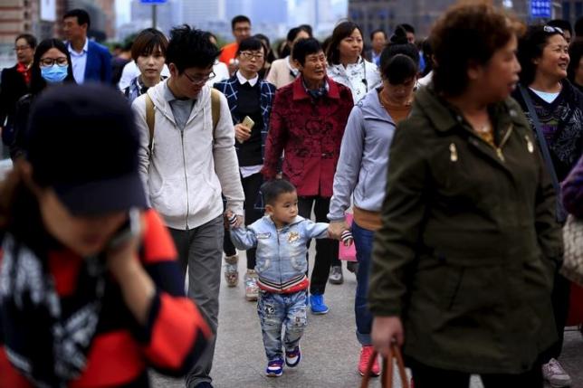 A little boy walks with his parents on a bridge in Shanghai, China, October 30, 2015.  Photo: REUTERS