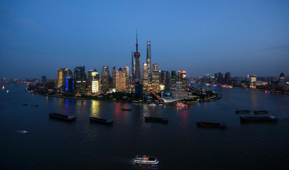 Ships pass by the Lujiazui Financial District in Shanghai on August 14, 2015. Photo: AFP 
