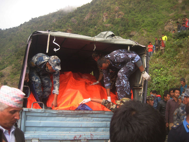Security personnel collecting the bodies of people killed in bus accident at Ramche of Rasuwa district.