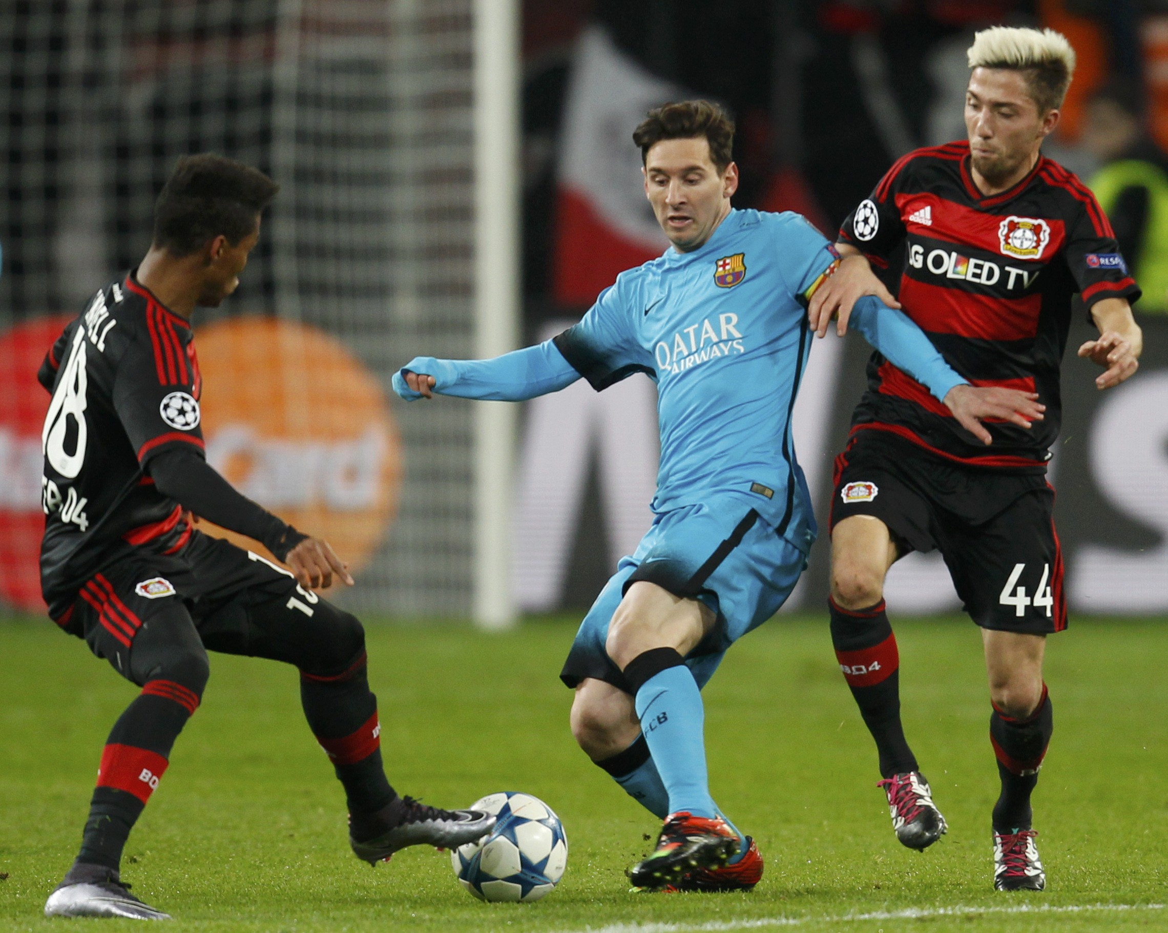FC Barcelona's Lionel Messi and Bayer Leverkusen's Kevin Kampl and Wendell in action during UEFA Champions League game at Leverkusen on Wednesday, December 9, 2015. Photo: Reuters