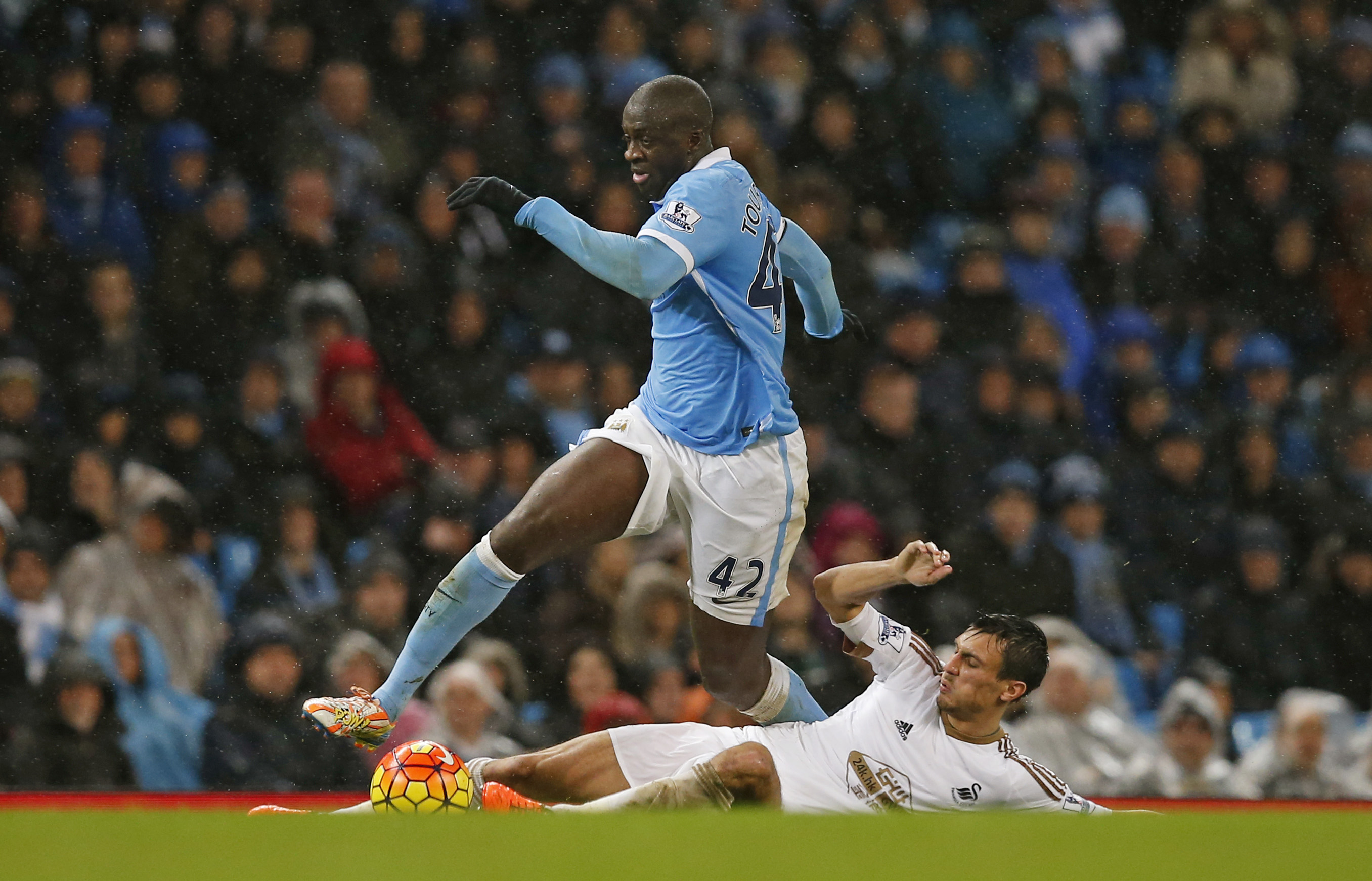 Manchester City's Yaya Toure in action with Swansea City's Jack Cork during Barclays Premier League game at Etihad Stadium on December 12, 2015. Photo: Reuters