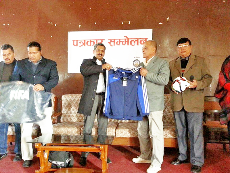 FIFA Development Officer Shaji Prabhakaran (left) nhanding over football kits to ANFA acting president nNarendra Shrestha as general secretary Dhirendra Pradhan holds the ball at a programme in Lalitpur non Tuesday, December 29, 2015. Photo: THT
