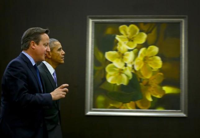 U.S. President Barack Obama chats with Britain's Prime Minister David Cameron after a working session at the Group of 20 (G20) leaders summit in the Mediterranean resort city of Antalya, Turkey, November 16, 2015. REUTERS/Ercin Top/Pool