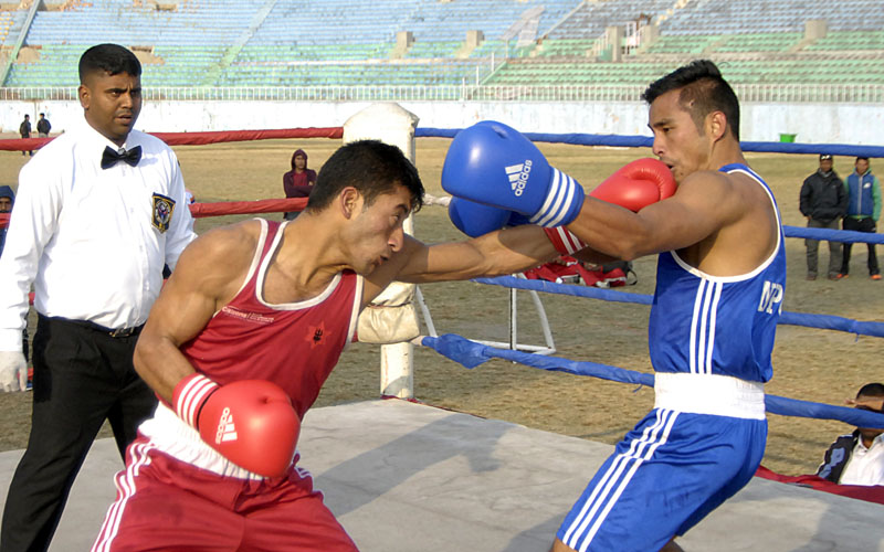 Diwana Sherma (left) of NPC lands a punch on the face of Lalita Maharjan of TAC during their 48-51kg bout at the SA Games selection tournament in Kathmandu. Photo: Udipt Singh Chhetry/THT