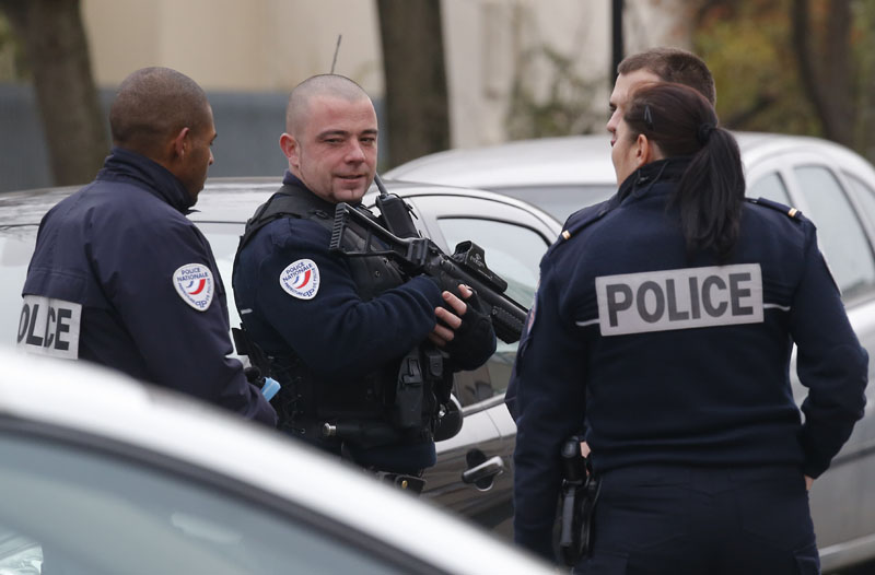 Police officers patrol near a pre-school, after a masked assailant with a box-cutter and scissors who mentioned the Islamic State group attacked a teacher on Monday, December14, 2015 in Paris suburb Aubervilliers. Photo: AP