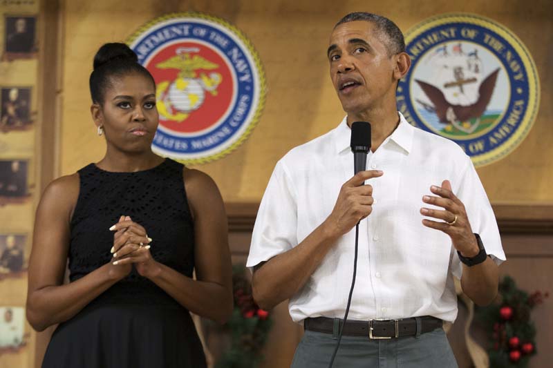 First lady Michelle Obama looks on as President Barack Obama speaks during an event to thank service members and their families at Marine Corp Base Hawaii, on Friday, on December 25, 2015, in Kaneohe Bay, Hawaii. Photo: AP
