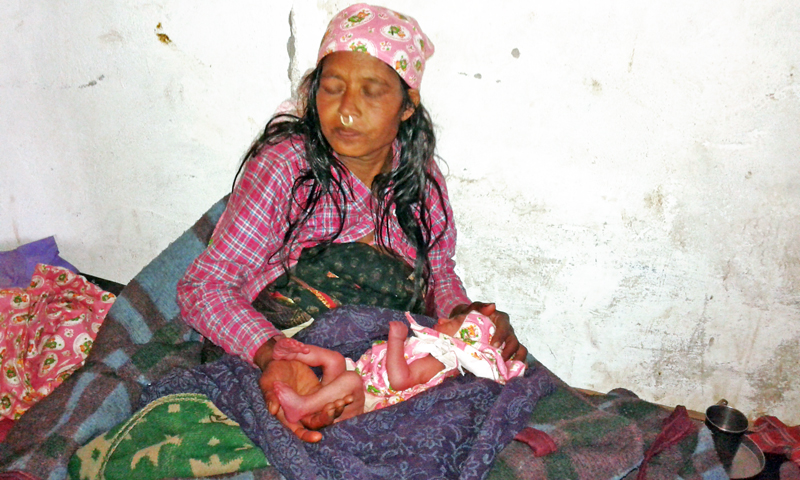 Chhamma Luwar (45)  of Gotri-8 in Bajura district receives medical treatment after giving birth to a child at Primary Health Centre in Kolti of the district. Photo: Prakash Singh
