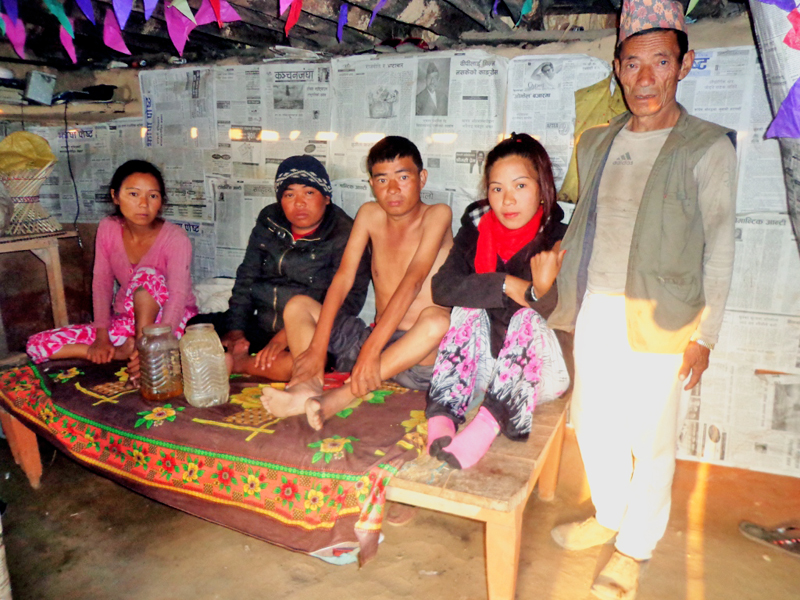 Polio-infected four members of a same family - (from left) Sirmaya, Khadga, Mahendra and Tara - with their father Harkabir Tamang at their house in Ingbung VDC-7 of Panchthar on Wednesday, December 23, 2015. Photo: Laxmi Gauta.