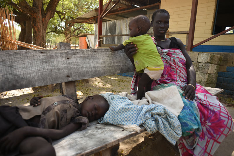Nyawel (Top) sits with her two sick children in a Doctors Without Borders clinic in Leer town, South Sudan on Tuesday December 15,  2015. Tuesday marks the 2 year anniversary of South Sudan's civil war. Photo: AP