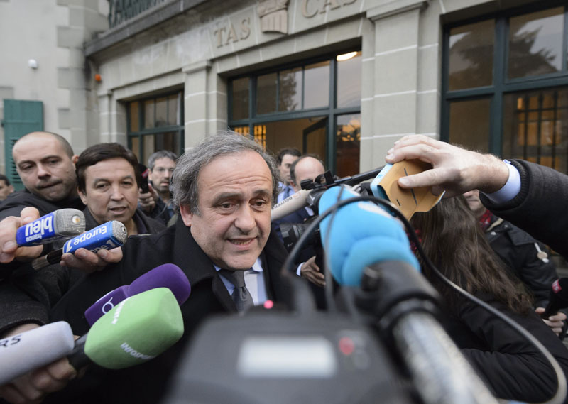 UEFA-President Michel Platini of France is surrounded by media after a hearing at the international Court of Arbitration for Sport, CAS, in Lausanne, Switzerland on Tuesday, December 8, 2015. Photo: AP
