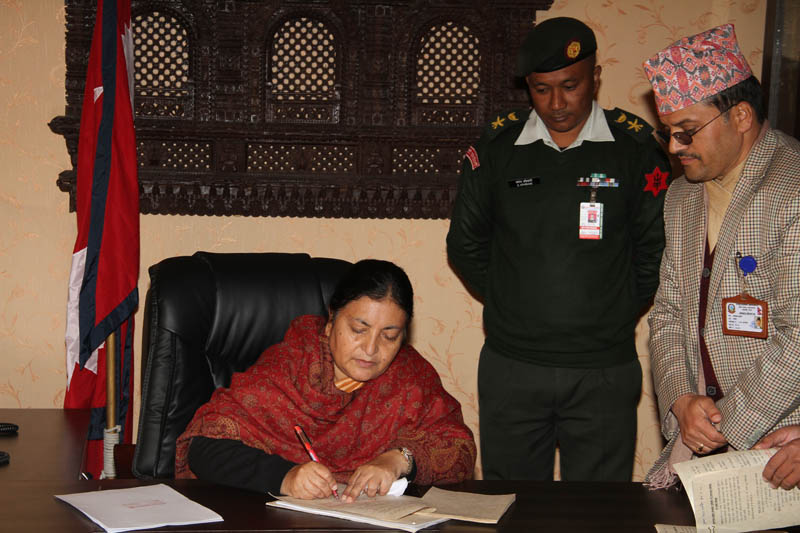 President Bidya Devi Bhandari enacts the Bill on Reconstruction of Earthquake Affected Structures at the Sheetal Niwas, on Sunday, December 20, 2015. Photo: President's Office