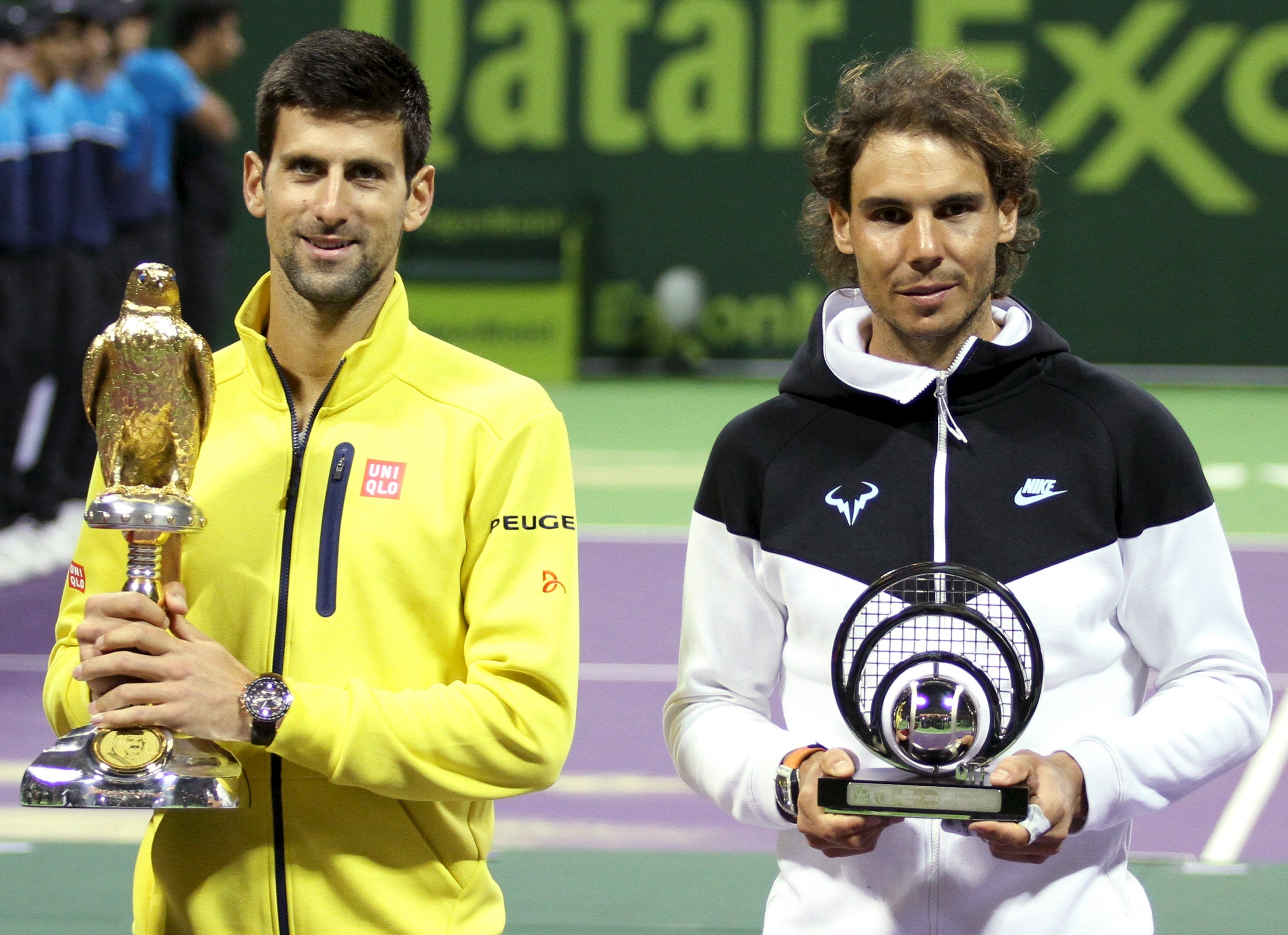 Novak Djokovic (left) of Serbia holds the trophy as he stands next to second place Rafael Nadal of Spain after winning his Qatar Open men's single tennis final match in Doha, Qatar, January 9, 2016. Photo: Reuters