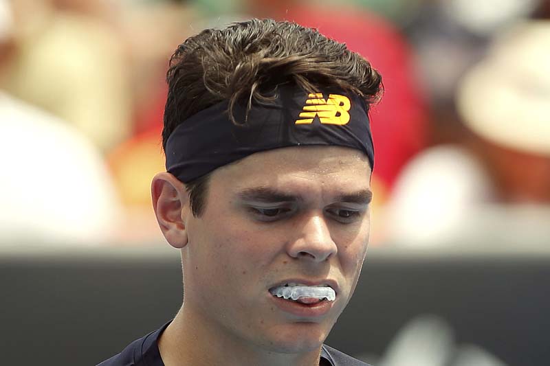 Canada's Milos Raonic wears a mouthguard during his first round match against France's Lucas Pouille at the Australian Open tennis tournament at Melbourne Park, Australia, on January 19, 2016. Photo: Reuters