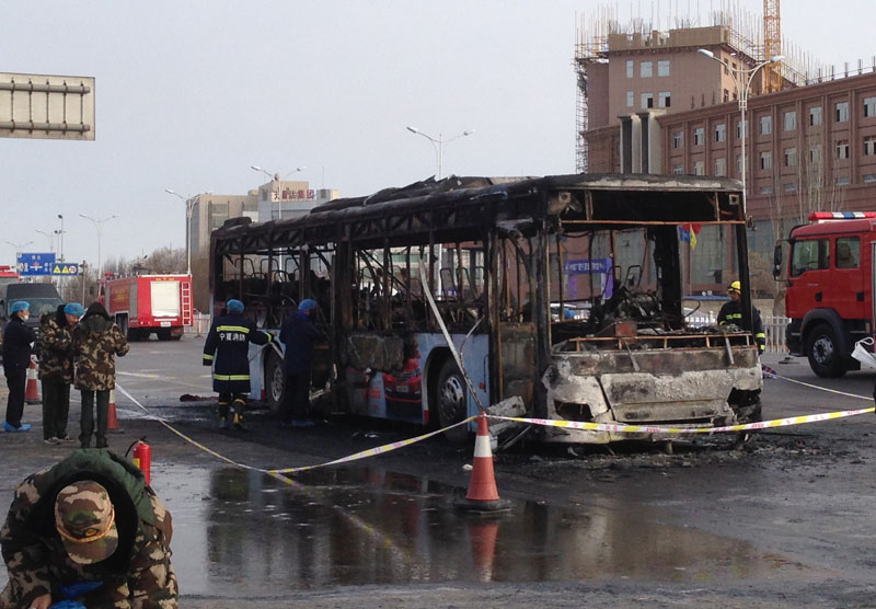 In this photo provided by China's Xinhua News Agency, firefighters work at an accident site of a bus fire in Yinchuan, the capital of Ningxia region, on Tuesday, January 5, 2016. Photo: via AP