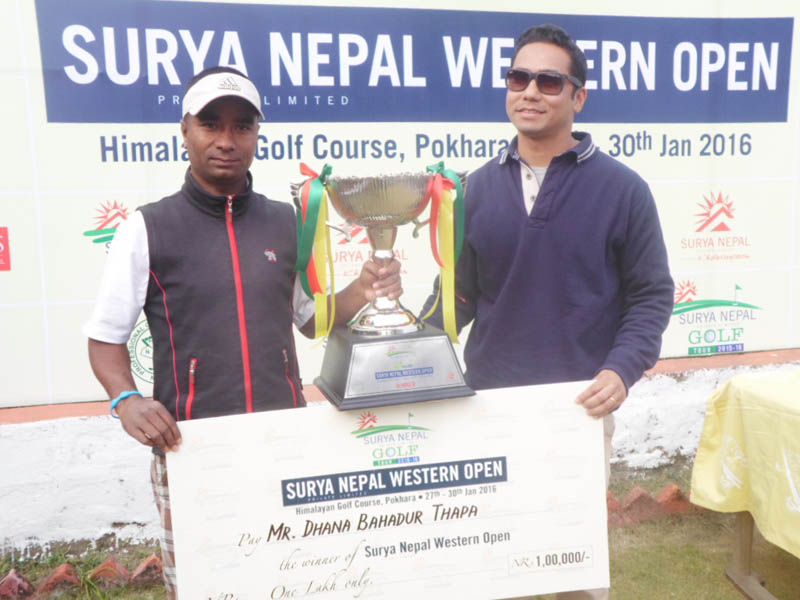 Surya Nepal Pvt Ltd Brand Manager Rajat Thapa handing over the trophy and cheque to Dhana Bahadur Thapa (left) after the Surya Nepal Western Open at the Himalayan Golf Course in Pokhara on Friday. Photo: Courtesy NPGA
