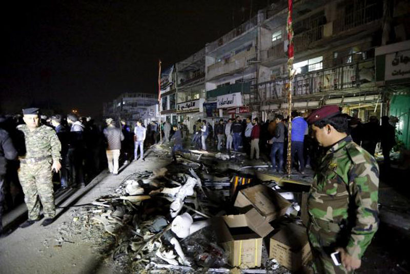 Iraqi security forces gather at the site of a car bomb in New Baghdad, January 11, 2016. Photo: Reuters