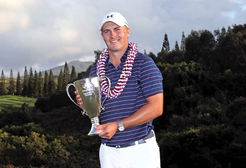 Jordan Spieth of the USA holds the trophy after winning Tournament of Champions at Kapalua Plantation Course in Hawaii on Sunday. Photo: AP