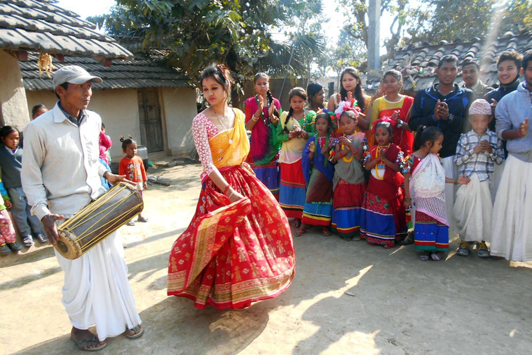 A Tharu girl performs traditional Maghauta dance on dholak beats while celebrating Maghi festival in Kanchanpur district, on Saturday, January 16, 2016. According to Tharu folklore, performing dance on each and every house, alleviates poverty. Photo: RSS