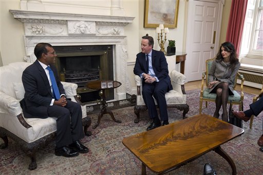 British Prime Minister David Cameron, center, meets with Former Maldives president Mohamed Nasheed, left, and British lawyer Amal Clooney inside 10 Downing Street in London, Saturday, Jan. 23, 2016. Former Maldives president Mohamed Nasheed left the Maldives on Monday for Sri Lanka after resolving a last-minute legal dispute with the government over his 30-day release for the spinal cord surgery in the UK. (Justin Tallis/Pool Photo via AP)