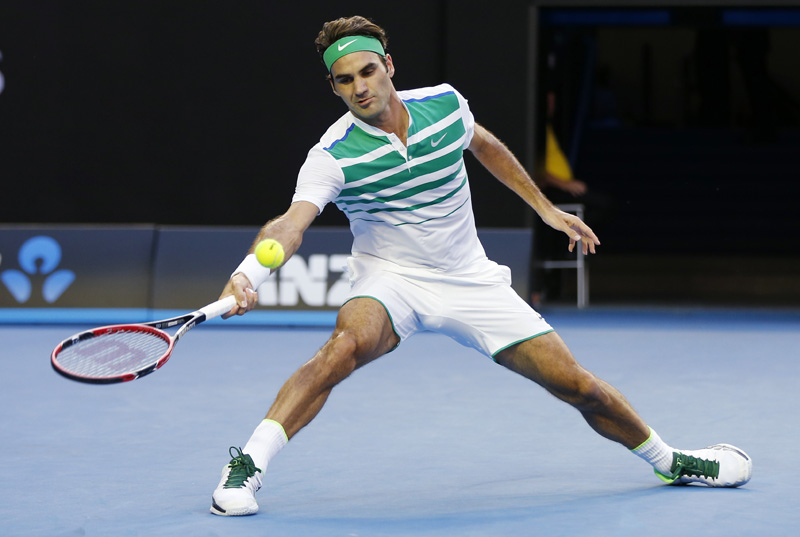 Roger Federer of Switzerland looks to make a forehand return to Nikoloz Basilashvili of Georgia during their first round match at the Australian Open tennis championships in Melbourne, Australia, Monday, January 18, 2016. Photo: AP