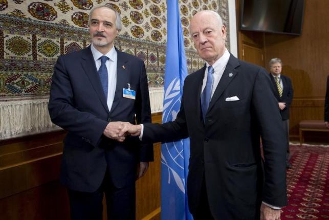 U.N. envoy Staffan de Mistura shakes hands with Syria's Ambassador to the United Nations Bashar al Jaafari (L) during the Syria peace talks in Geneva, Switzerland, January 29, 2016. REUTERS/Jean-Marc Ferre/United Nations/Handout via Reuters