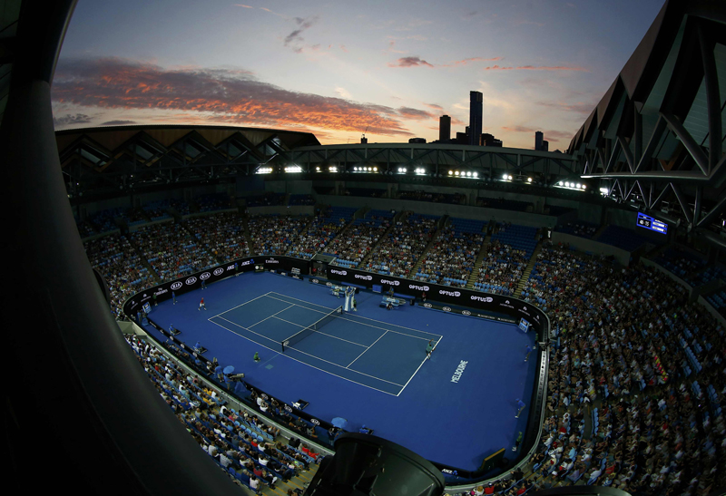 The sun sets as France's Jo-Wilfried Tsonga serves during his second round match against Australia's Omar Jasika at the Australian Open tennis tournament at Melbourne Park, Australia, January 20, 2016. Photo: Reuters