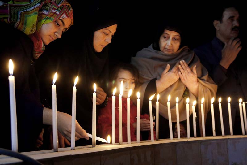 Pakistani women light candles during a vigil for victims of the Bacha Khan University attack, on Wednesday, January 20, 2016 in Peshawar, Pakistan. Photo: AP