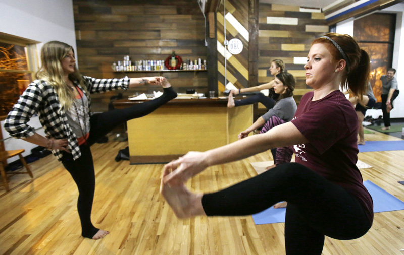 This Thursday, Dec. 3, 2015 shows Cori Dermer, right, and Melissa Klimo-Major practicing yoga at the Platform Beer Co, in Cleveland. Craft breweries are partnering up with yoga studios around the country as more breweries are hosting classes to attract a new crowd to the bars and yoga studios are using the beer to get more men to try yoga. Photo: AP