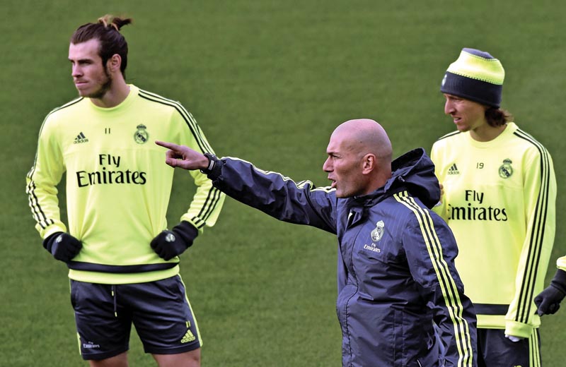 Real Madrid's newly-appointed French coach Zinedine Zidane points his finger next to Gareth Bale (left) and Luka Modric during a team training session at the Valdebebas ground in Madrid on Friday. Photo: AFP