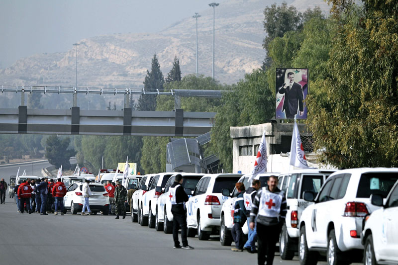A convoy consisting of Red Cross, Red Crescent and United Nations gather before heading towards Madaya from Damascus, and to al Foua and Kefraya in Idlib province, on Monday.  Photo: Reuters