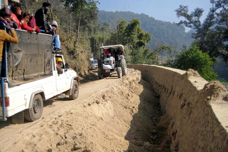 Vehicles passing along the Kamalbinayak-Nagarkot road, being upgraded by the Road Improvement Committee under the Department of Road, in Bhaktapur on Saturday, January 3, 2016. Photo: RSS