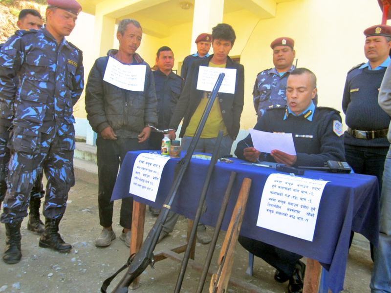 Police making two persons, who were arrested for making guns, public at a press meet organised in District Police Office, Rukum, on Tuesday, February 23, 2016. Photo: THT