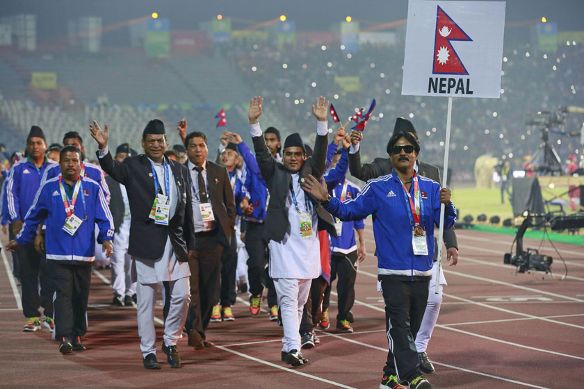 Nepali players wave as they march during the closing ceremony of the South Asian Games in Gauhati, India, Tuesday, February 16, 2016. Photo: AP