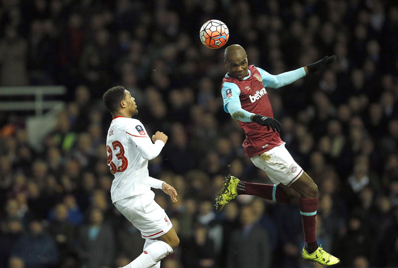 West Ham's Angelo Ogbonna (right) vies for the ball with  Liverpool's Jordan Ibe during their FA Cup match at Boleyn Ground Stadium, in London, on Tuesday. Photo: AFP