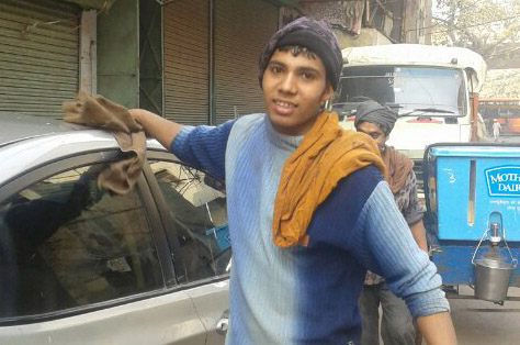 Prakash Chadara of Bahrabisa in Bajura district washing a car in New Delhi, India.  Photo: THT
