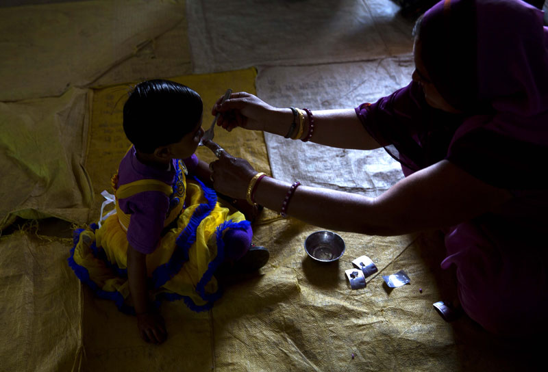 A health worker administers a deworming pill to a girl in a village in Neemrana , 123 kilometres (76.8 miles) from New Delhi, in the Indian state of Rajasthan, on Wednesday, February 10, 2016. Photo: AP