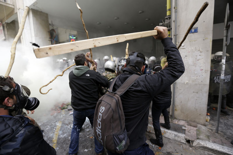 Farmers clash with riot police during a protest outside Agriculture ministry in Athens, on Friday, February 12, 2016. Photo: AP