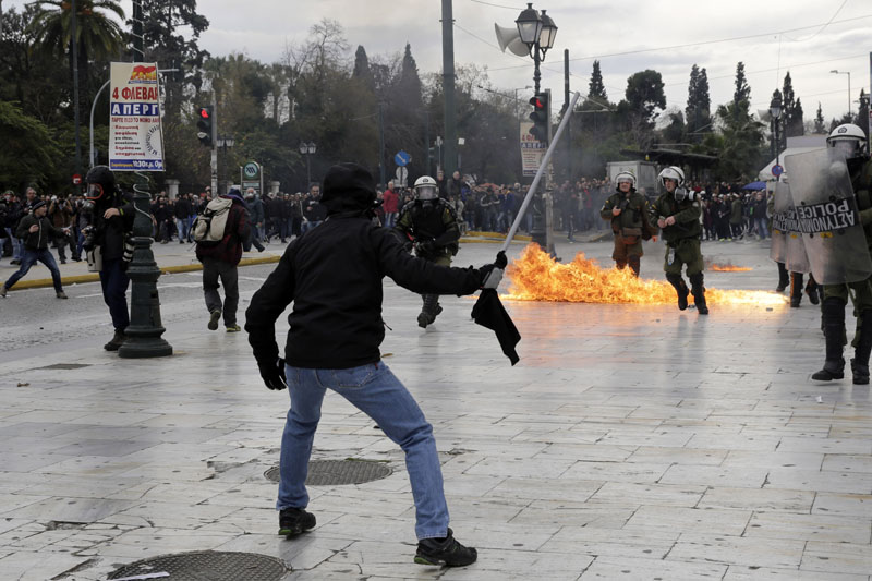 Protesters clash with riot police during a 24-hour nationwide general strike in Athens, on Thursday, February 4, 2016. Photo: AP