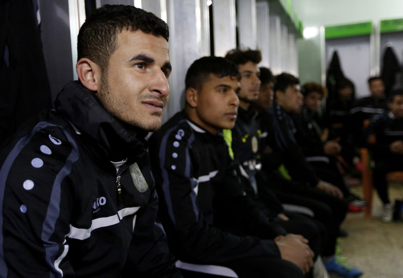Soccer player Ayman Hussein (left) sits with his team in a locker room in Baghdad, Iraq, on Saturday, February 6, 2016. Photo: AP