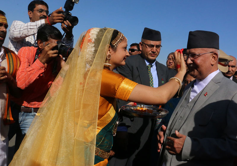 A woman putting tika to Prime Minister KP Sharma Oli at the Bhuj Airport in Gujarat on Tuesday, February 23, 2016. Photo: RSS 