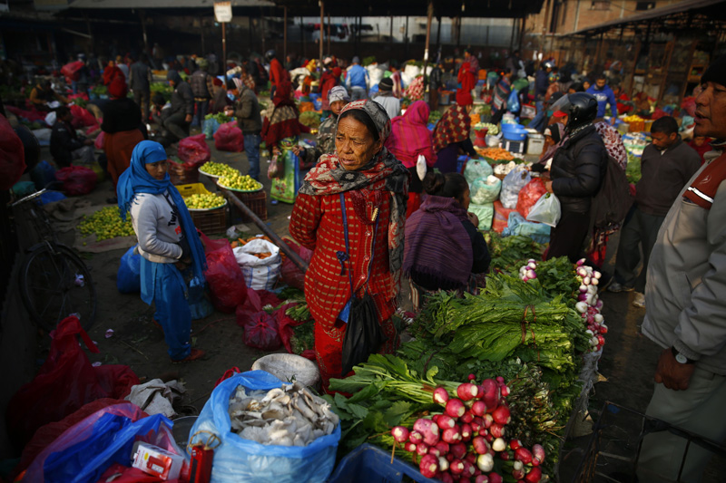 A vendor waits for customers to sell vegetables at Kalimati fruit and vegetable market in Kathmandu on Sunday. Photo: Skanda Gautam