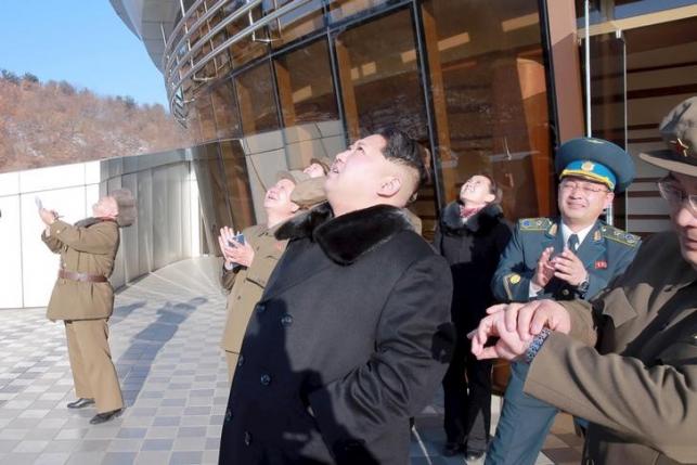 North Korean leader Kim Jong Un (C) watches a long range rocket launch into the air in North Korea, in this photo released by Kyodo February 7, 2016. REUTERS/Kyodo