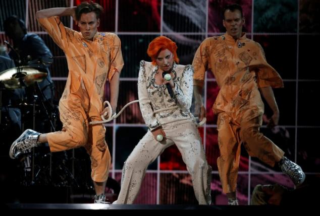 Lady Gaga is tied with a rope as she performs a medley of songs as a tribute to the late David Bowie. REUTERS/Mario Anzuoni